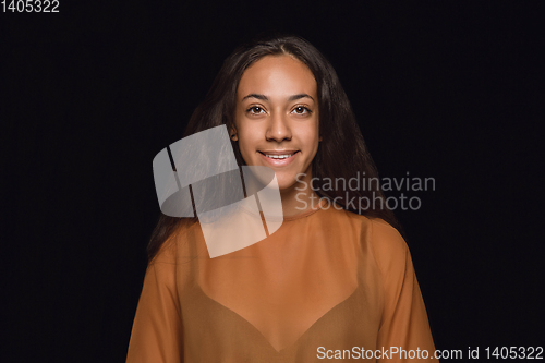 Image of Close up portrait of young woman isolated on black studio background