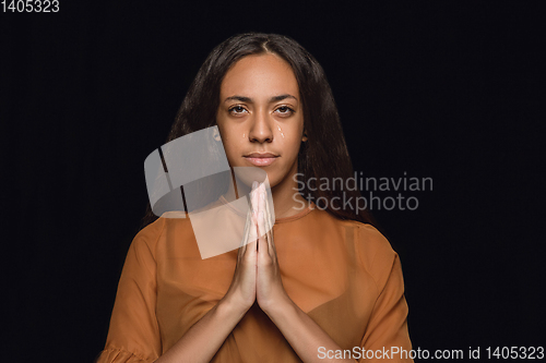 Image of Close up portrait of young woman isolated on black studio background