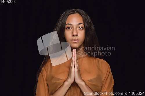 Image of Close up portrait of young woman isolated on black studio background