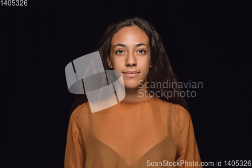 Image of Close up portrait of young woman isolated on black studio background