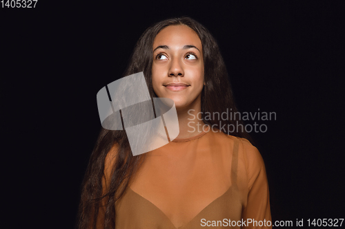 Image of Close up portrait of young woman isolated on black studio background