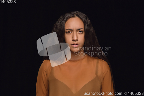 Image of Close up portrait of young woman isolated on black studio background