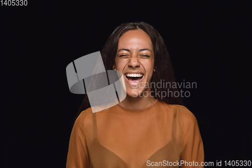 Image of Close up portrait of young woman isolated on black studio background