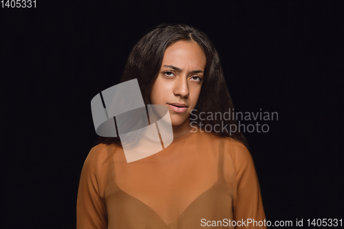 Image of Close up portrait of young woman isolated on black studio background