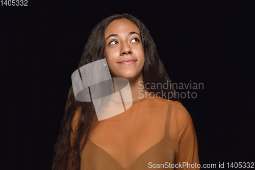 Image of Close up portrait of young woman isolated on black studio background