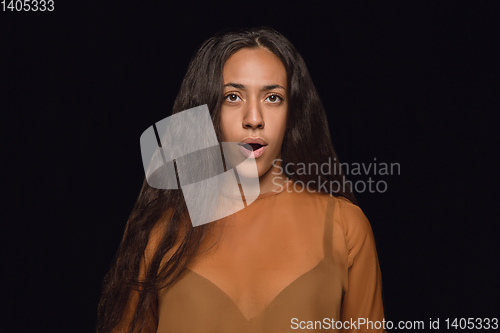 Image of Close up portrait of young woman isolated on black studio background