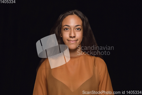 Image of Close up portrait of young woman isolated on black studio background