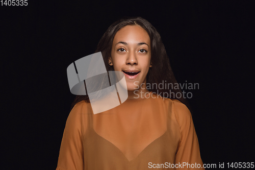 Image of Close up portrait of young woman isolated on black studio background