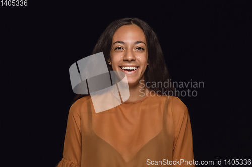 Image of Close up portrait of young woman isolated on black studio background