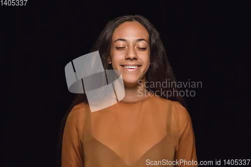 Image of Close up portrait of young woman isolated on black studio background