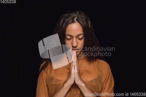 Image of Close up portrait of young woman isolated on black studio background