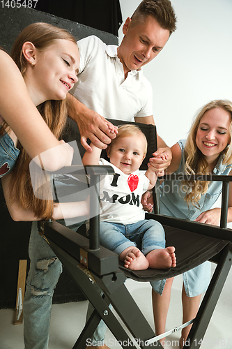 Image of Young family spending time together and smiling