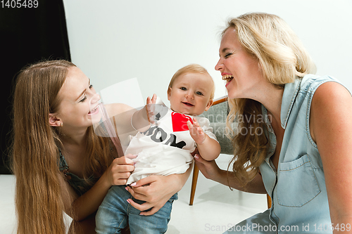 Image of Young family spending time together and smiling