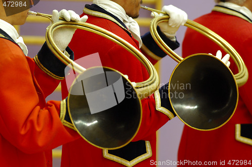 Image of details of musicians playing on hunting horns