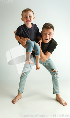 Image of Happy father holding adorable little son and smiling