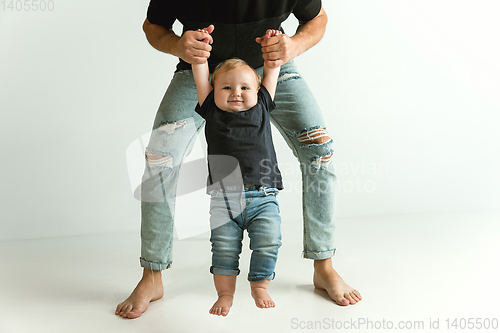 Image of Happy father holding adorable little son and smiling