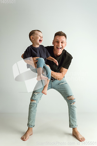 Image of Happy father holding adorable little son and smiling