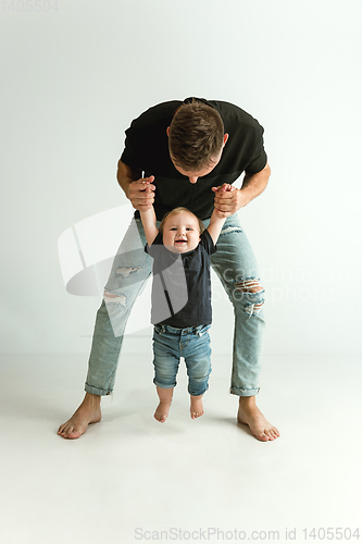 Image of Happy father holding adorable little son and smiling