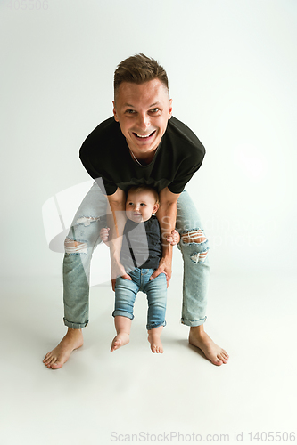 Image of Happy father holding adorable little son and smiling