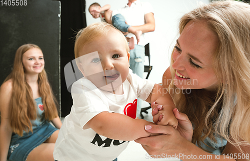 Image of Young family spending time together and smiling