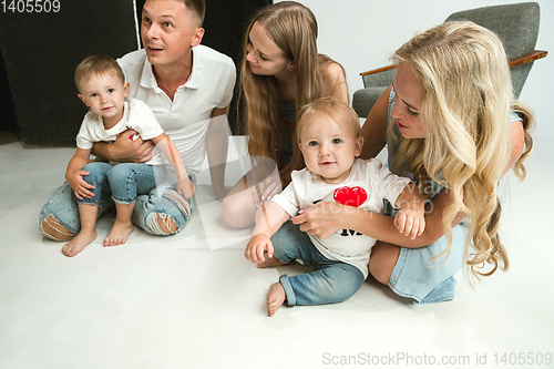 Image of Young family spending time together and smiling