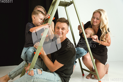 Image of Young family spending time together and smiling