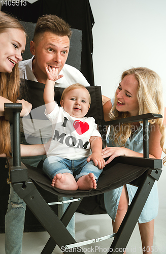 Image of Young family spending time together and smiling