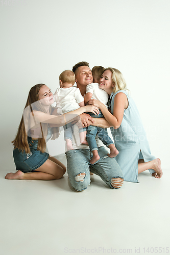 Image of Young family spending time together and smiling