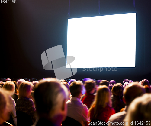 Image of Crowd audience looking at screen