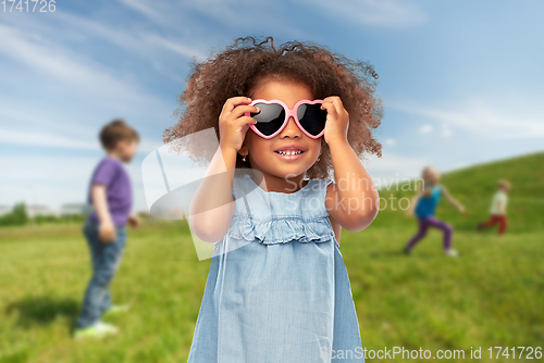 Image of little african girl in heart shaped sunglasses