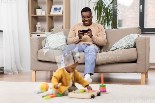 Image of happy father with tablet pc and baby at home