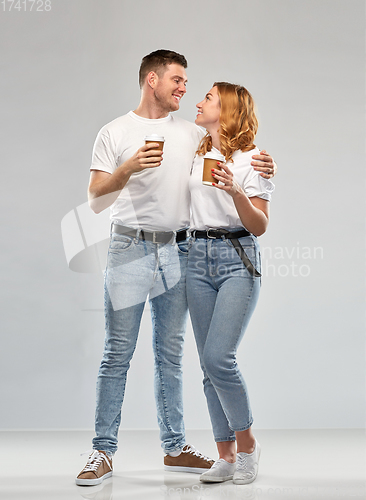 Image of portrait of happy couple with takeaway coffee cups