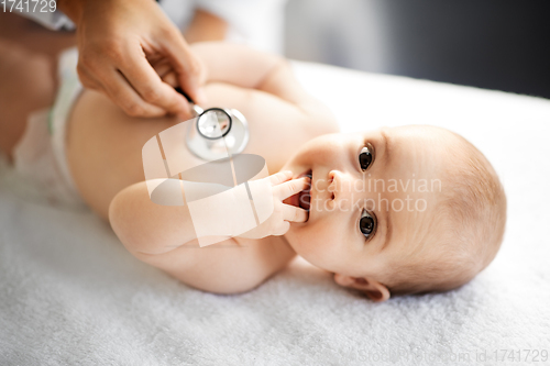 Image of doctor with stethoscope listening to baby patient