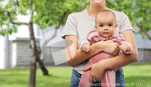 Image of happy young mother holding little baby daughter