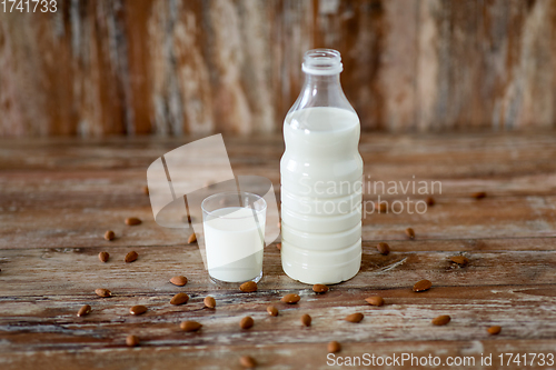 Image of milk and almonds on wooden table