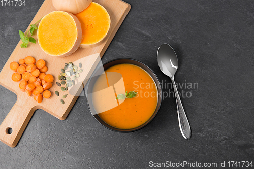 Image of vegetable pumpkin cream soup in bowl with spoon