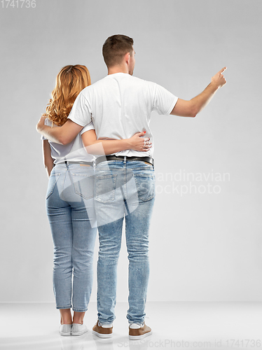 Image of happy couple in white t-shirts hugging