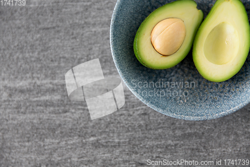 Image of close up of ripe avocado with bone in ceramic bowl