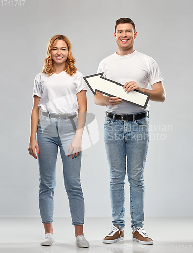 Image of happy couple in white t-shirts with arrow to left