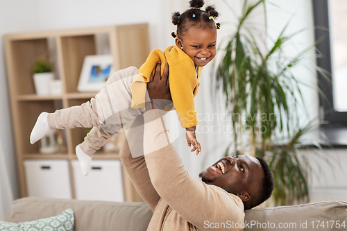 Image of happy african american father with baby at home