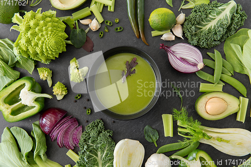 Image of green vegetables and cream soup in ceramic bowl