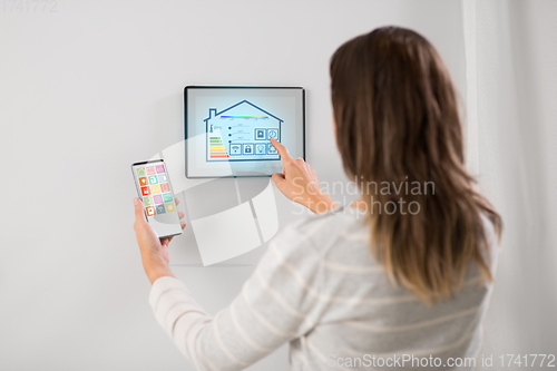 Image of woman using tablet computer and smartphone