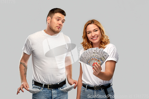 Image of couple with money and empty pockets