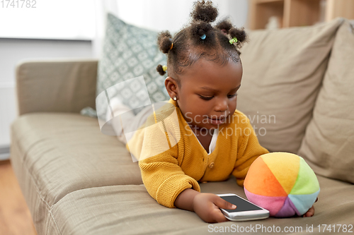 Image of african american baby girl with smartphone at home