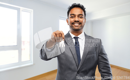 Image of indian man realtor with home keys at new apartment