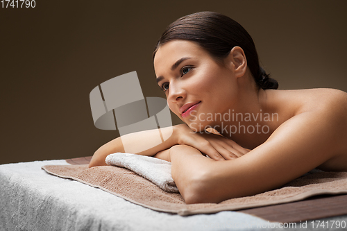 Image of young woman lying at spa or massage parlor