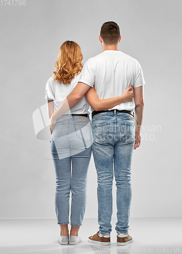 Image of happy couple in white t-shirts hugging