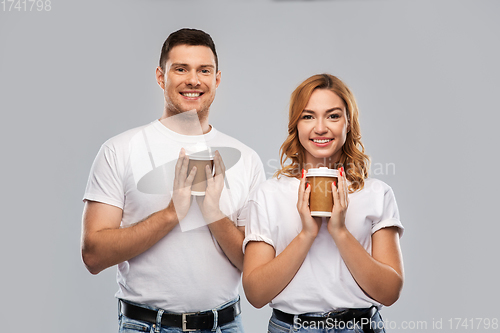 Image of portrait of happy couple with takeaway coffee cups