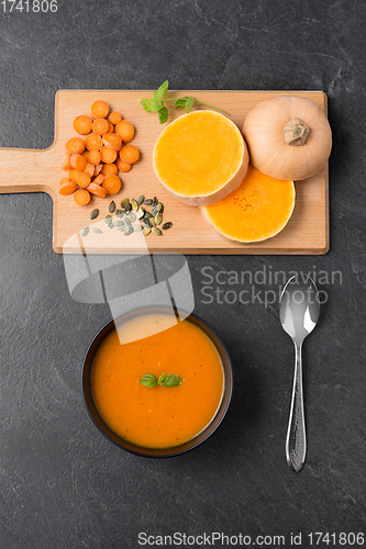 Image of vegetable pumpkin cream soup in bowl with spoon