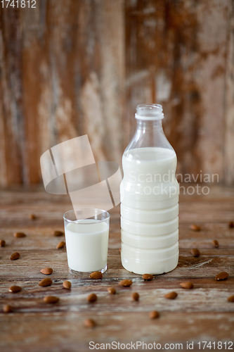 Image of milk and almonds on wooden table